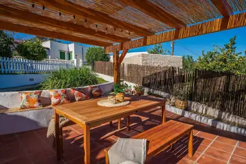Pergola with a table and long bench for six