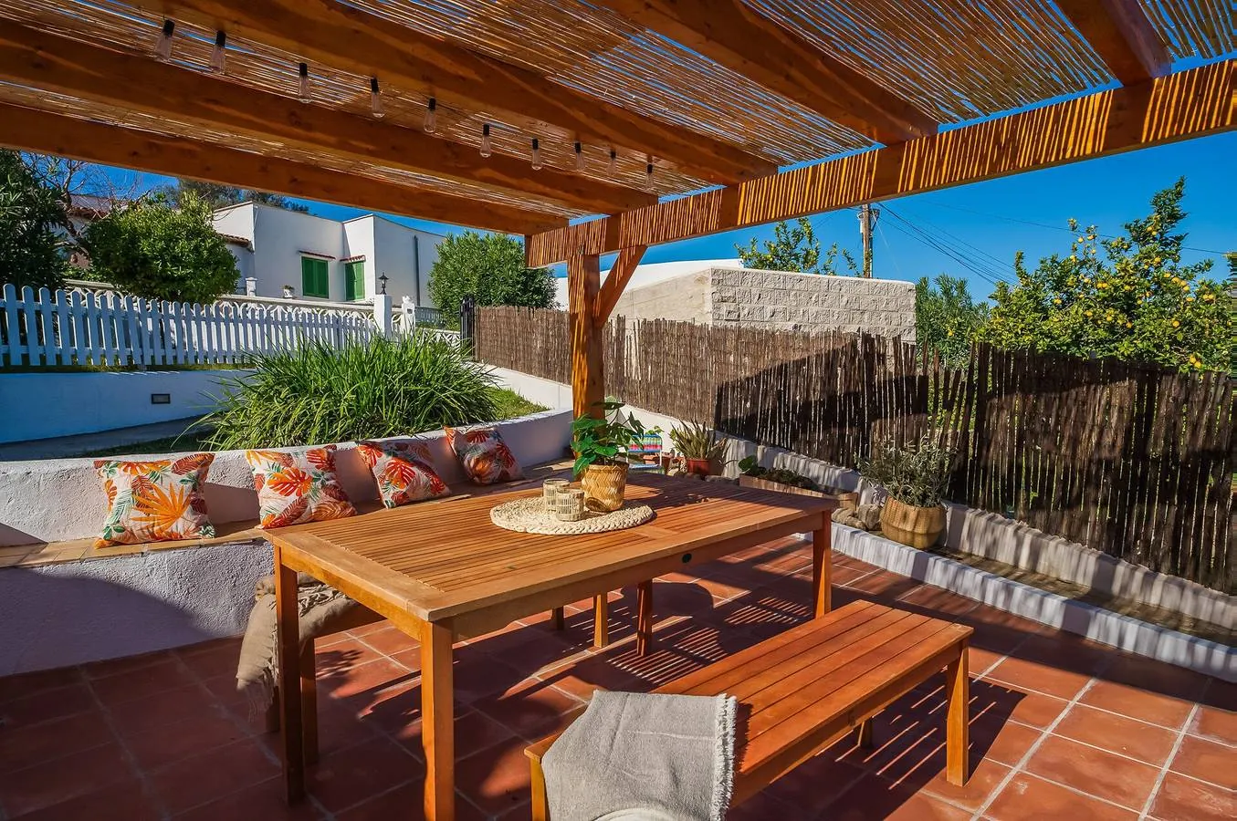 Wooden pergola with a table for six and a long bench