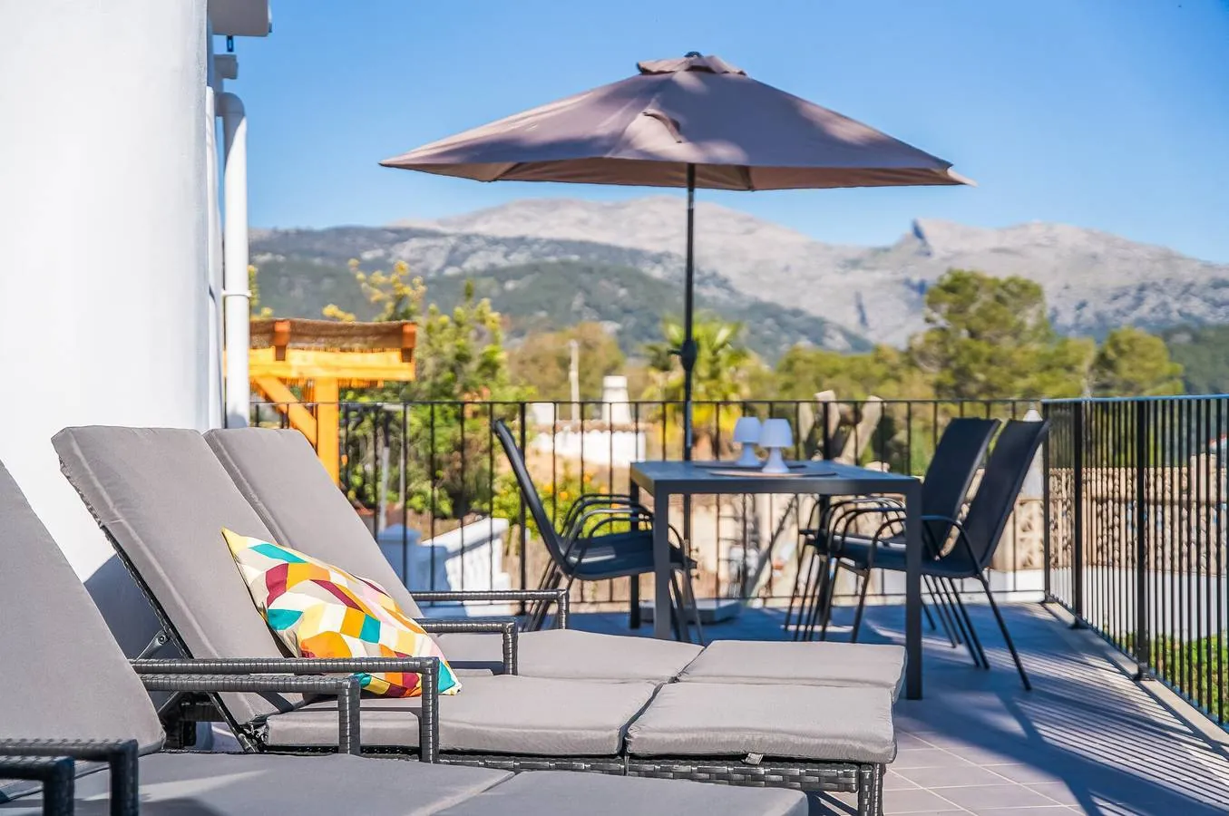 Sun loungers on the terrace with the Serra de Tramuntana behind